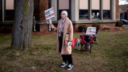 A volunteeer holds a "Vote Uncommitted" sign outside a polling station in Dearborn, Michigan, on February 27, 2024.