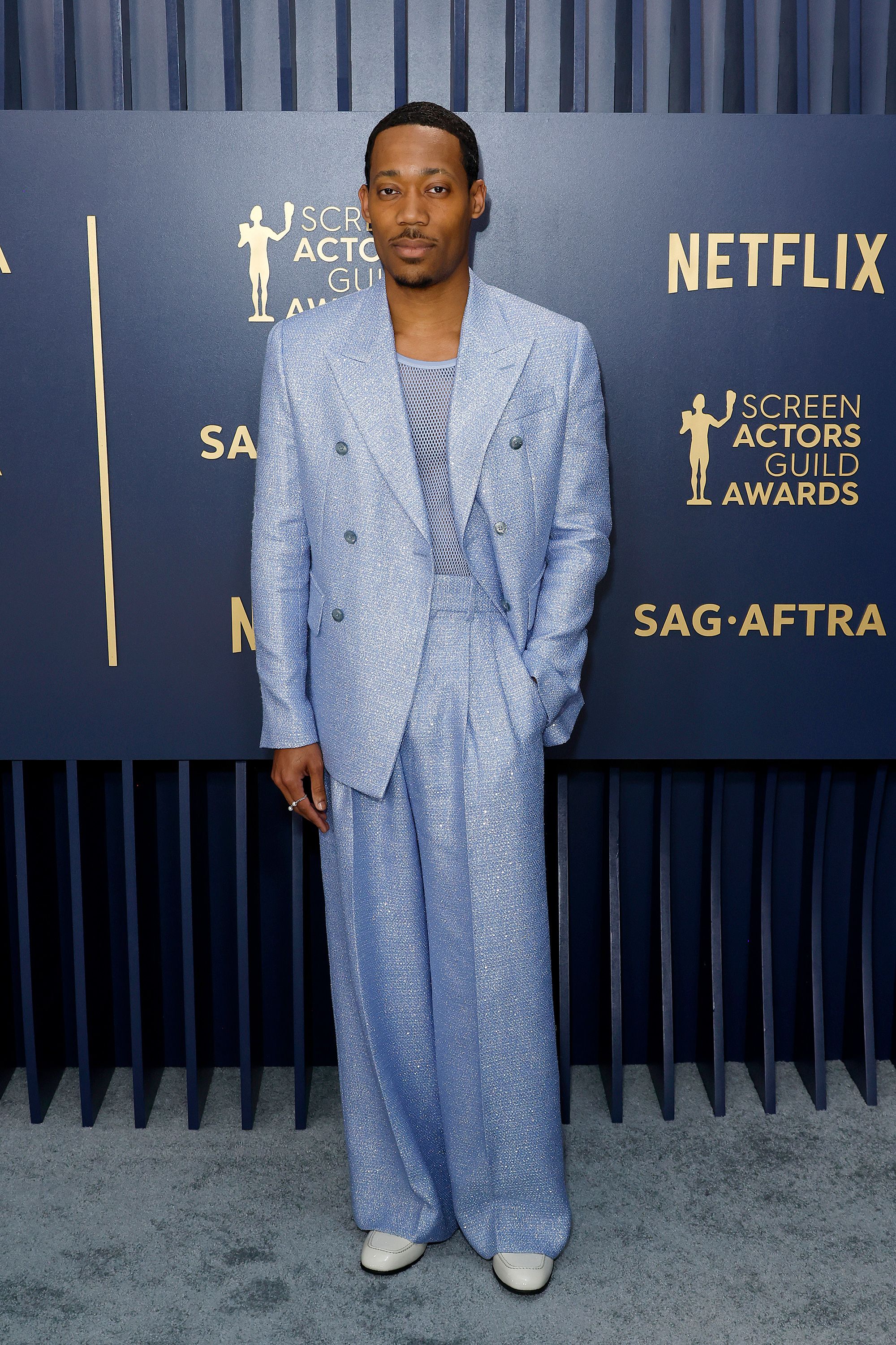 Tyler James Williams in a slouchy Amiri suit and matching mesh vest.