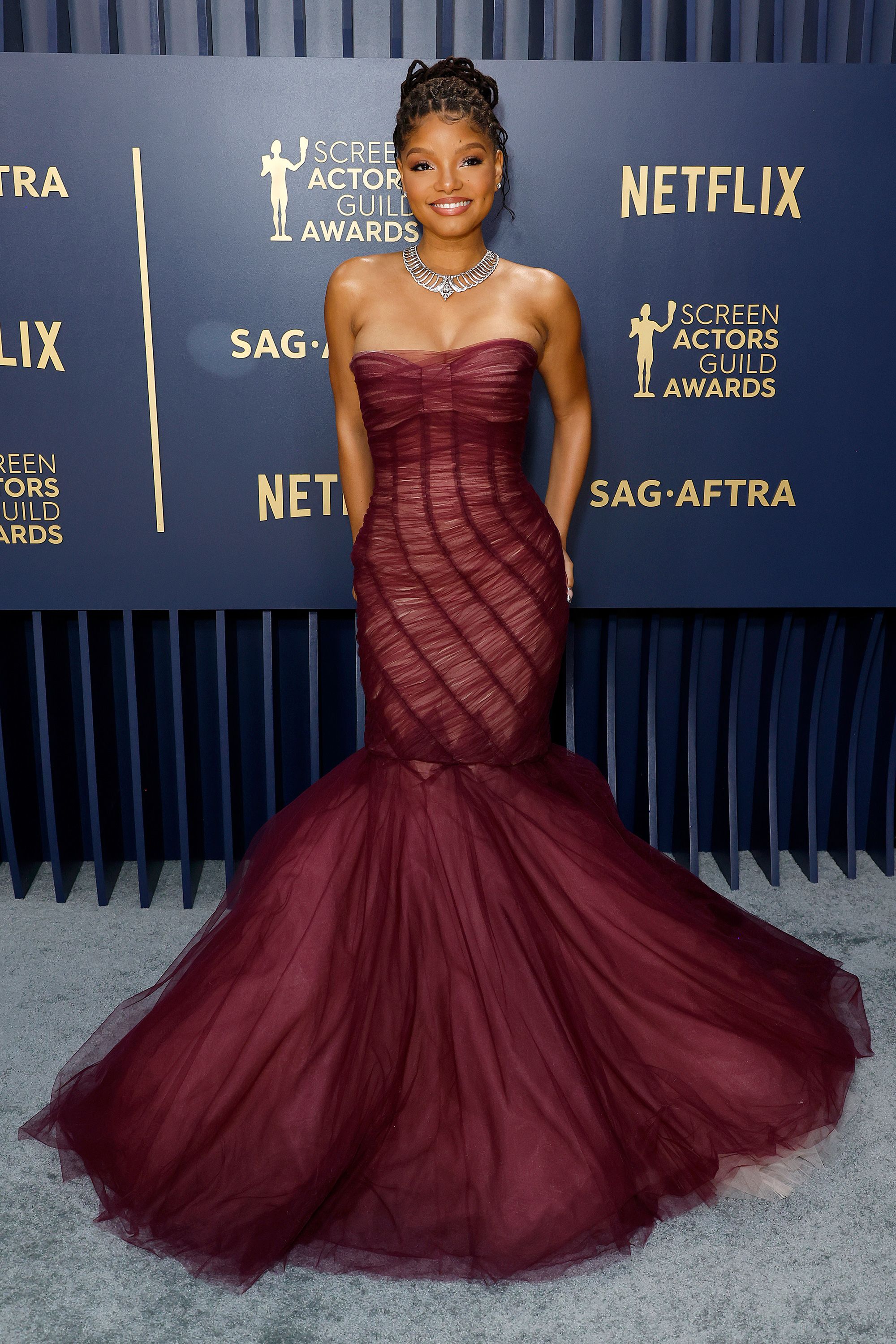 A mermaid moment for Halle Bailey, in a maroon tulle fishtail gown by Dolce & Gabbana.