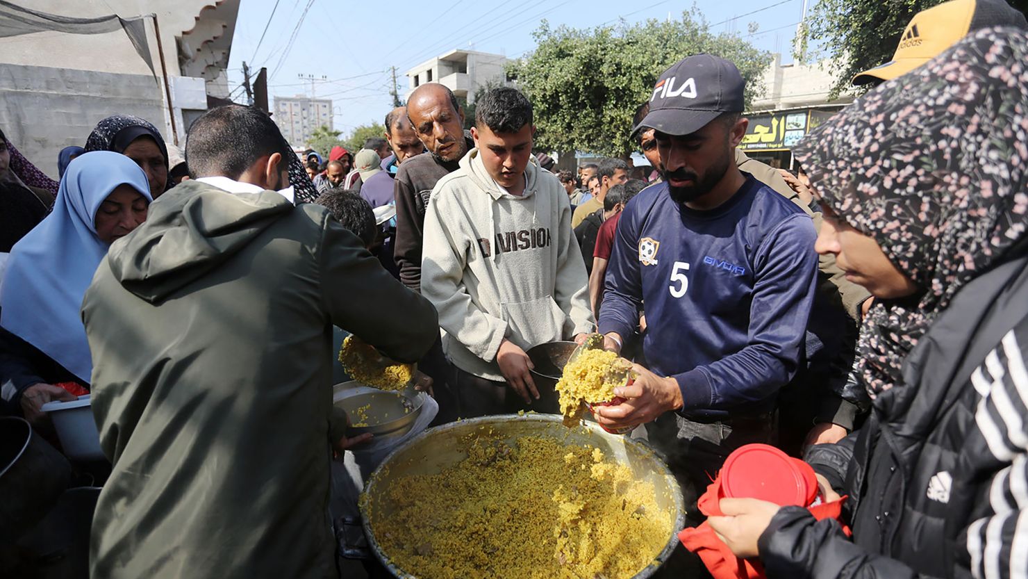 Palestinians wait in lines for several hours to receive food from charity organizations as they struggle to find food amid Israeli attacks in Deir al-Balah on February 27, 2024.