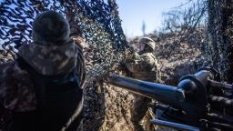 Ukrainian servicemen of 79th brigade cover a 105 mm howitzer with a camouflaged net near the frontline outside of Marinka as the war between Russia and Ukraine continues in Donetsk Oblast, Ukraine on February 28, 2024.