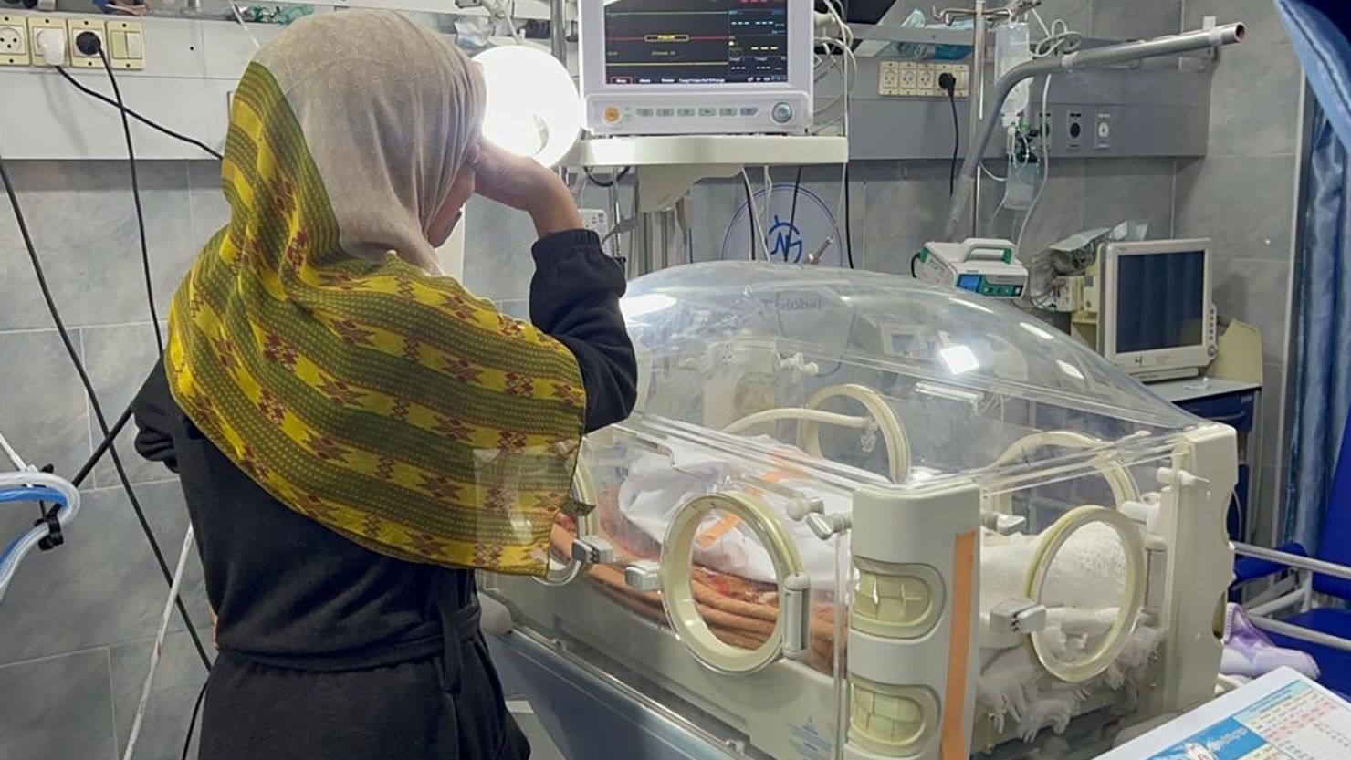 A mother cries for her baby in front of an incubator, with the baby's body inside, at Kamal Adwan Hospital in Beit Lahia, Gaza on February 29, 2024.