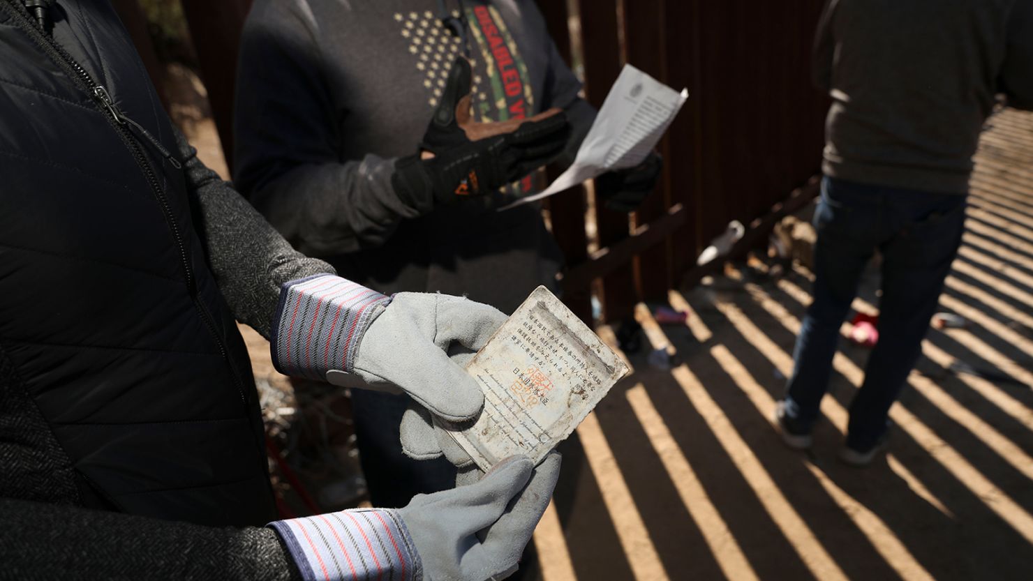A Border Vets volunteer holds a Chinese Passport found at the US-Mexico border on February 29, 2024 in Jacumba Hot Springs, California.