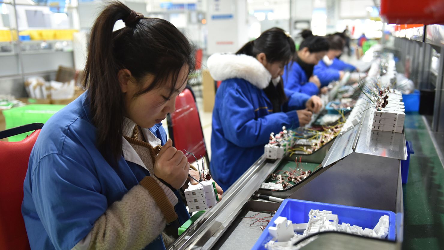 Workers at a circuit breaker production line in Fuyang, China, on March 1, 2024