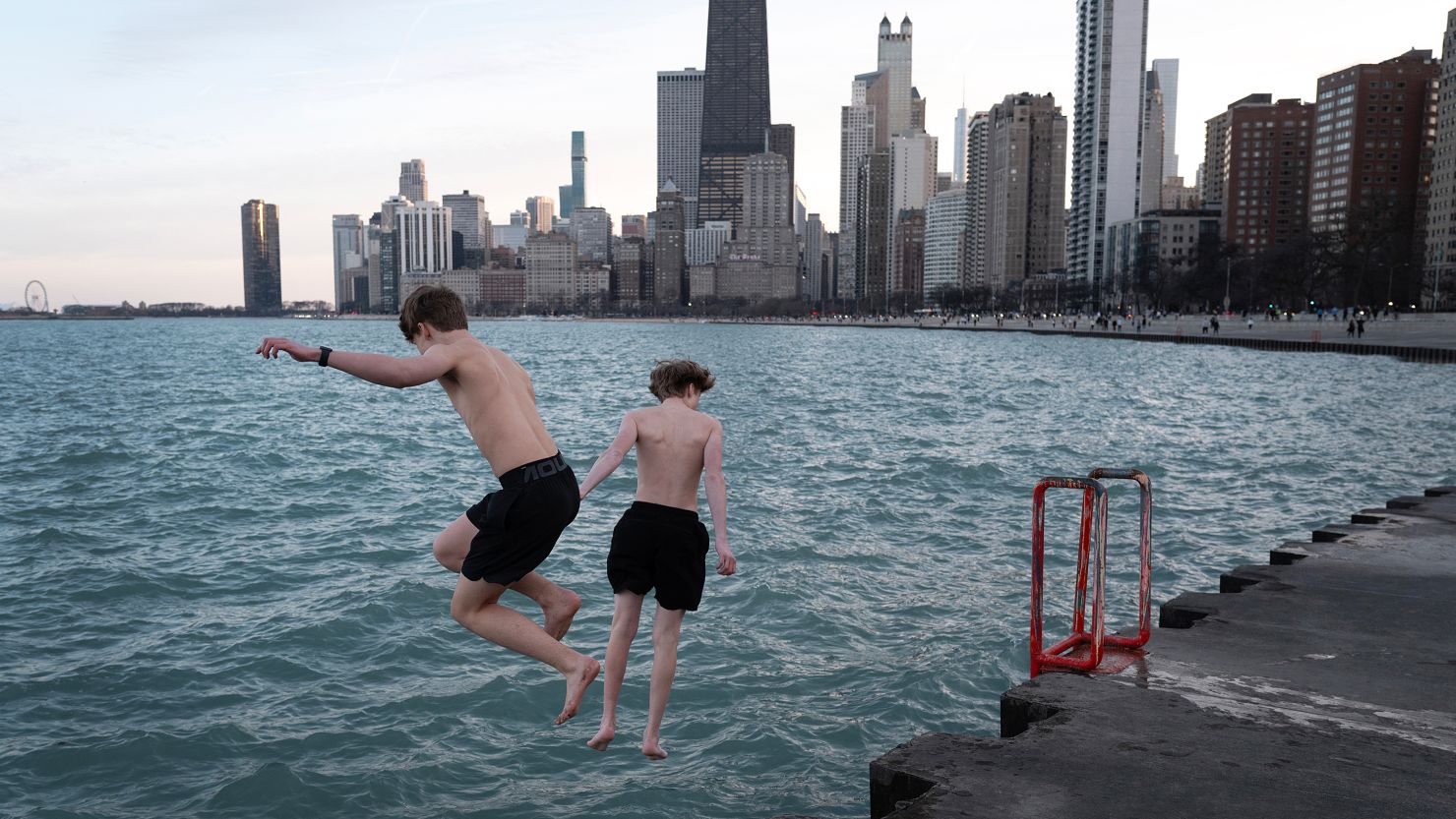 Kids jump into Lake Michigan during unseasonably warm conditions in Chicago on February 26, 2024.
