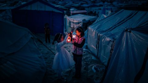 RAFAH, GAZA - FEBRUARY 29: Palestinian children taking refuge in Tel al-Sultan region due to Israeli attacks decorate their tents with Ramadan lanterns and illuminate lights ahead of the holy Islamic fasting month of Ramadan in Rafah, Gaza on February 29, 2024. (Photo by Belal Khaled/Anadolu via Getty Images)