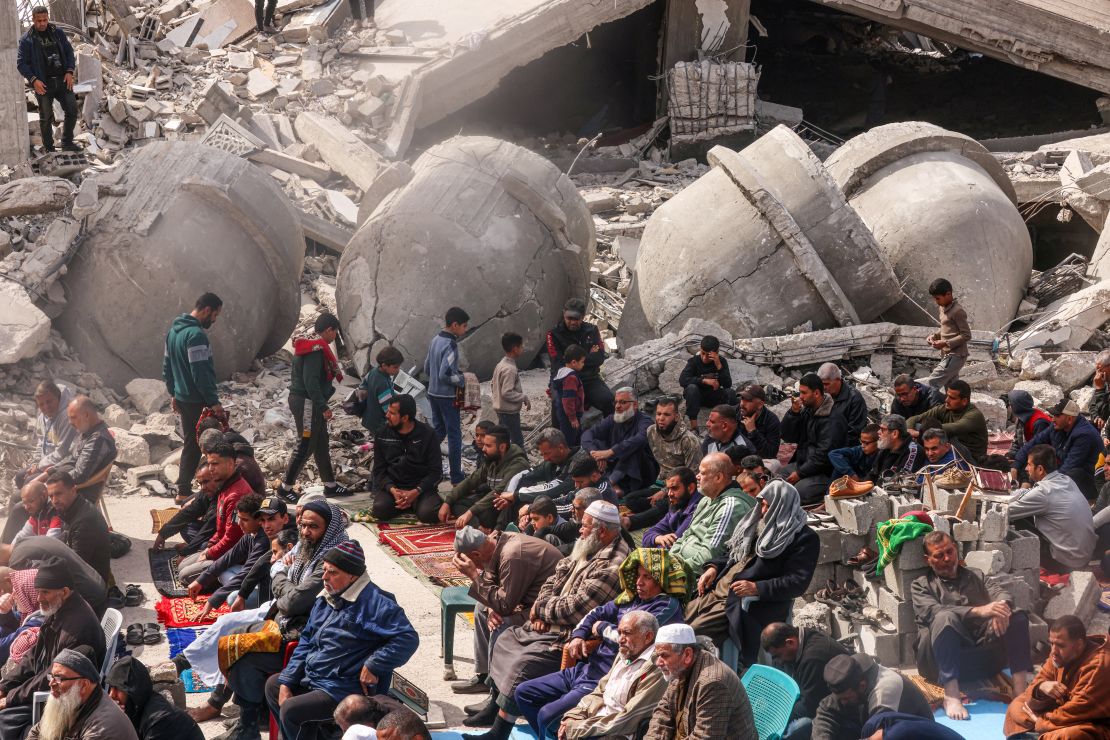 Palestinians perform the Friday noon prayers by the ruins of the al-Faruq mosque, destroyed by Israeli strikes in Rafah, in southern Gaza, on March 1.