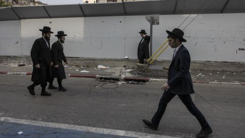 Ultra-Orthodox Jewish men walk in the central Israeli city of Bnei Brak on February 27, 2024. As Israelis are called up to join the war effort in Gaza, anger is mounting at the ultra-Orthodox community which has long been spared the compulsory military service required of most citizens. (Photo by Menahem Kahana / AFP)