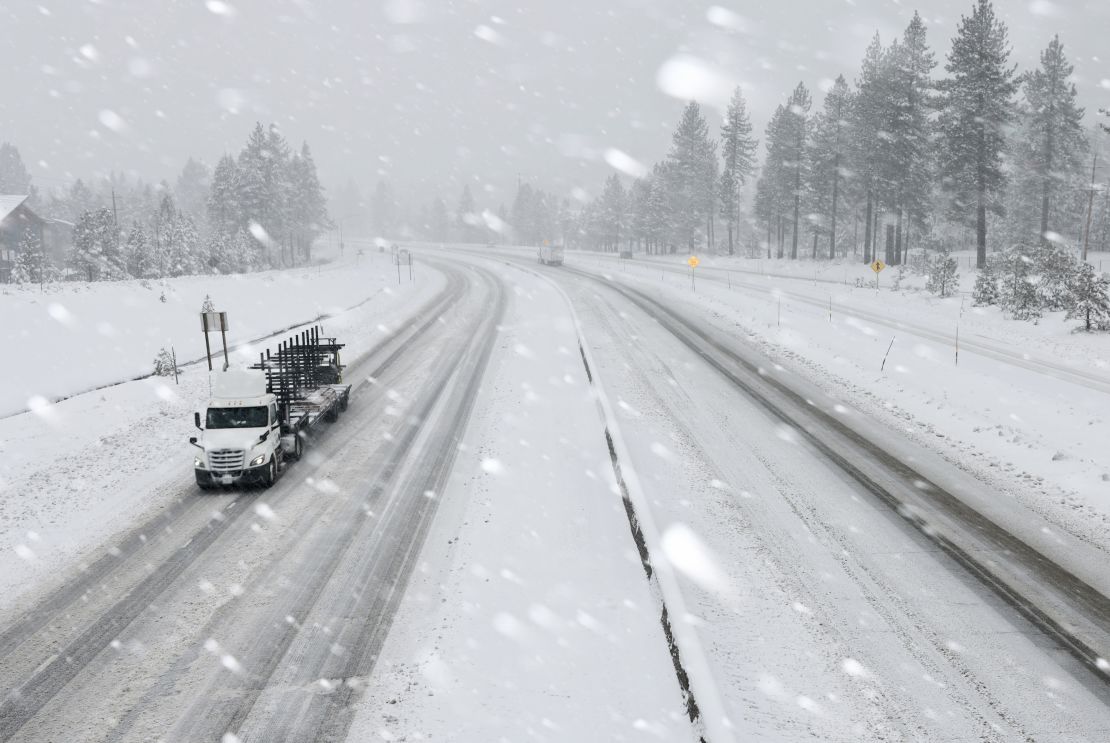 Vehicles drive on I-80 as snow hammers the region north of Lake Tahoe during a powerful winter storm on Friday, March 1, 2024, in Truckee, California.