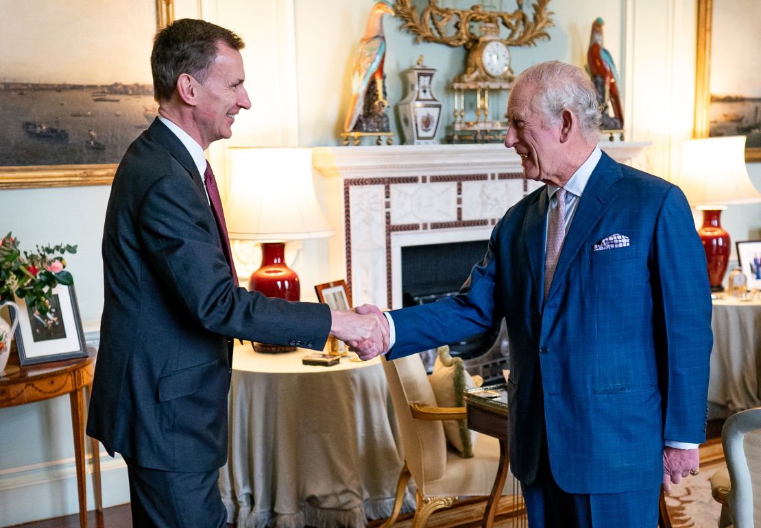 Charles III greets Chancellor of the Exchequer Jeremy Hunt in the private audience room at Buckingham Palace in London on Tuesday.