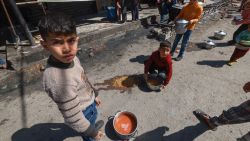 Palestinian children receive cooked food rations as part of a volunteer youth initiative in Rafah in the southern Gaza Strip, on March 5, 2024, amid widespread hunger in the besieged Palestinian territory as the conflict between Israel and the Palestinian militant group Hamas continues. (Photo by MOHAMMED ABED / AFP) (Photo by MOHAMMED ABED/AFP via Getty Images)