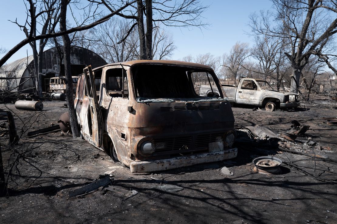 The charred remains of vehicles sit behind a shop that was destroyed by the Smokehouse Creek fire when it burned its way through the Texas Panhandle on March 2, 2024.
