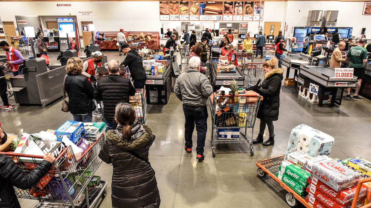 Customers check out at a Costco store in Teterboro, New Jersey, US, on Wednesday, Feb. 28, 2024.