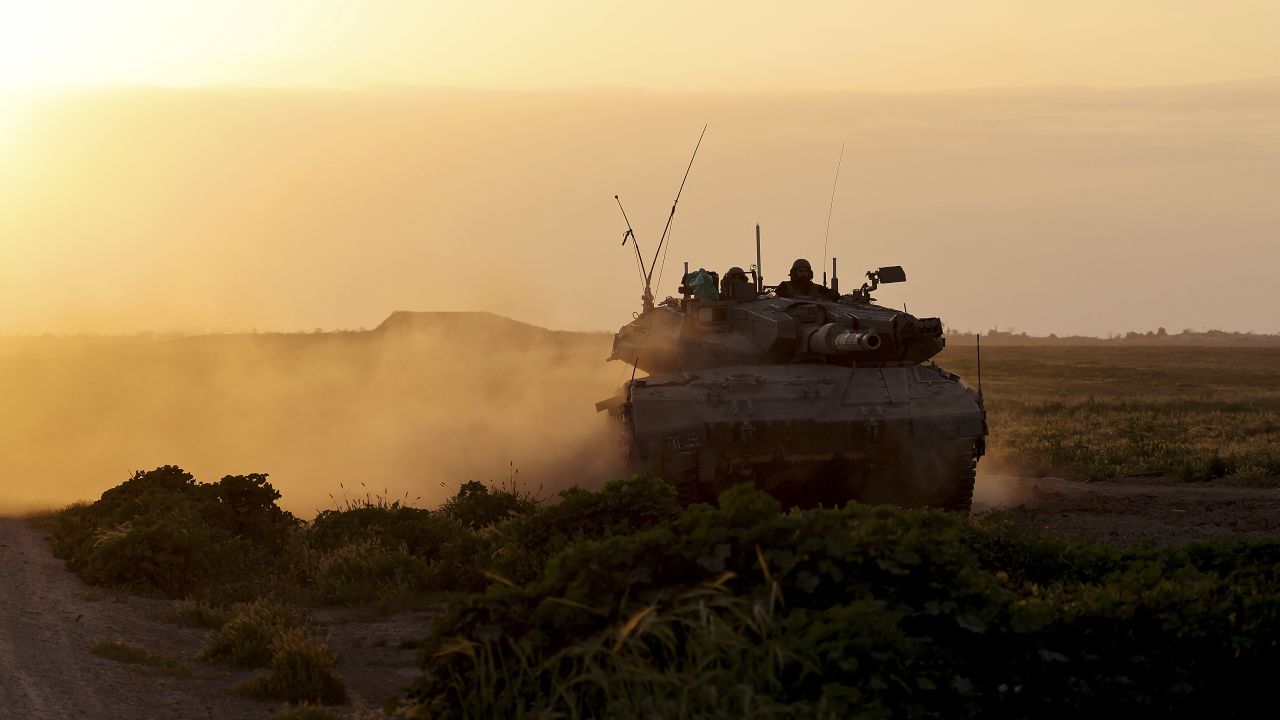 TOPSHOT - A picture taken from Israel near the border with the Gaza Strip on March 6, 2024 shows an Israeli army tank moving along the border area, as battles between Israel and the Palestinian militant group Hamas continue. (Photo by JACK GUEZ / AFP) (Photo by JACK GUEZ/AFP via Getty Images)
