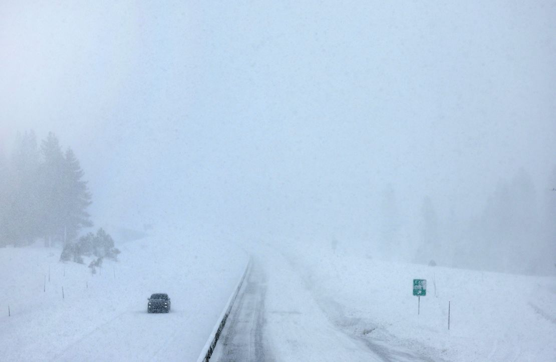 A vehicle drives through a section of Interstate 80 that is closed in Truckee, California on Sunday.