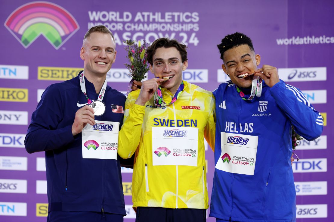 Duplantis (center) celebrates his second world indoor title.