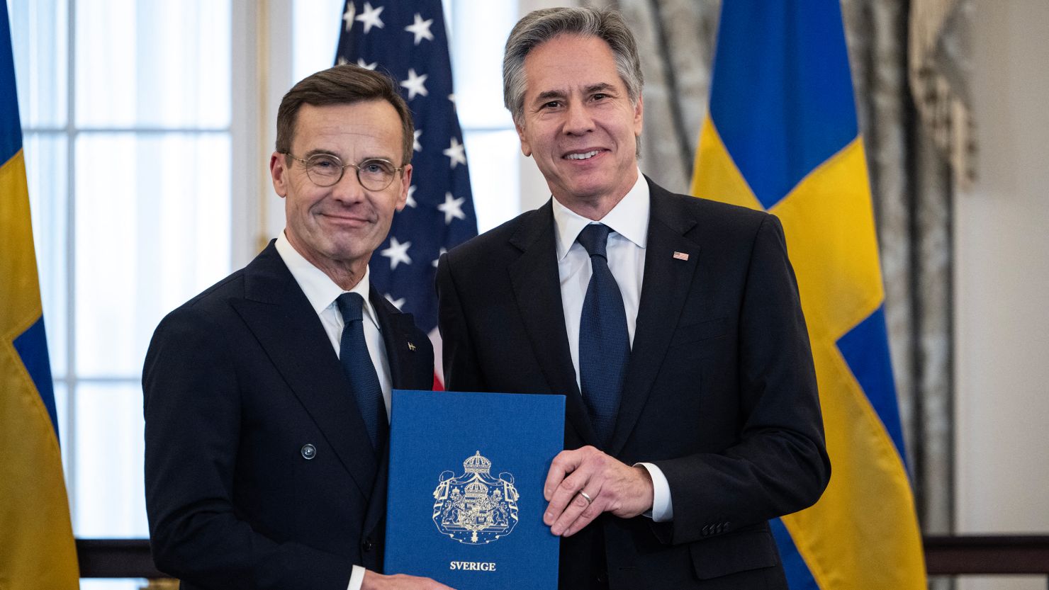 Swedish Prime Minister Ulf Kristersson hands accession documents to US Secretary of State Antony Blinken, March 7, 2024.