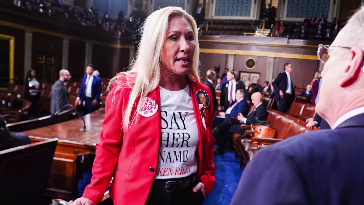 Rep. Marjorie Taylor Greene chats on the floor of the House of Representatives ahead of President Joe Biden's State of the Union address in the House Chamber of the US Capitol in March.