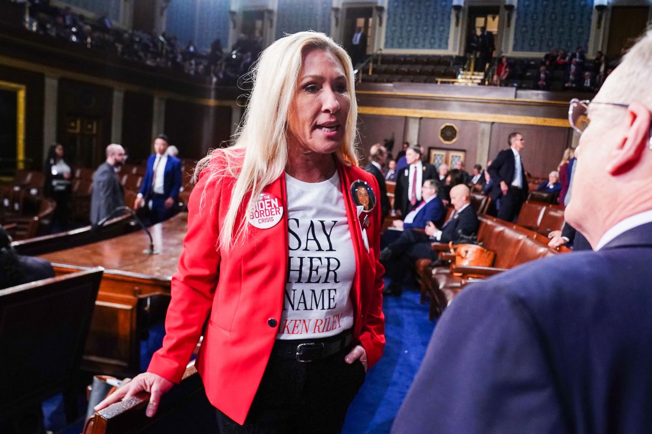 Rep. Marjorie Taylor Greene chats on the floor of the House of Representatives ahead of President Joe Biden's State of the Union address in the House Chamber of the US Capitol in March.