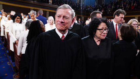 U.S. Supreme Court Chief Justice John Roberts, in a crowd of people inside the U.S. Capitol. 