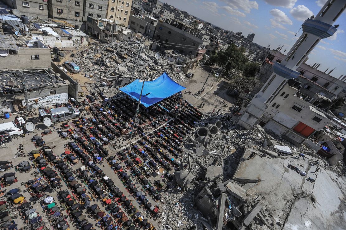 Palestinians perform Friday prayers at the Al-Farouq Mosque, which was destroyed by Israeli bombardment, in Rafah, in southern Gaza, on March 8.