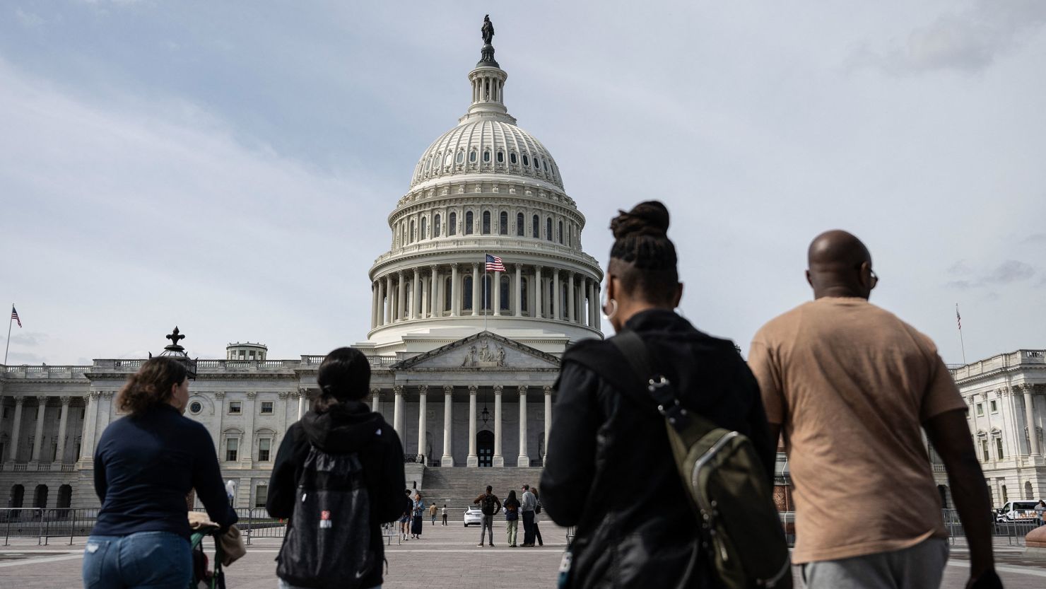 A group of people walk towards the US Capitol in Washington, DC, on March 8.