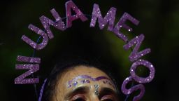A woman wears a head ornament with the legend "Ni una menos (not one less)" during a march to mark the International Women's Day in Buenos Aires, on March 8, 2024. (Photo by Luis ROBAYO / AFP) (Photo by LUIS ROBAYO/AFP via Getty Images)