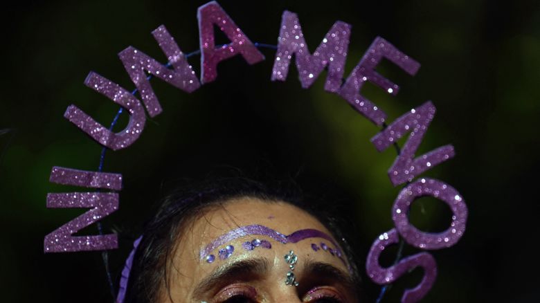 A woman wears a head ornament with the legend "Ni una menos (not one less)" during a march to mark the International Women's Day in Buenos Aires, on March 8, 2024. (Photo by Luis ROBAYO / AFP) (Photo by LUIS ROBAYO/AFP via Getty Images)
