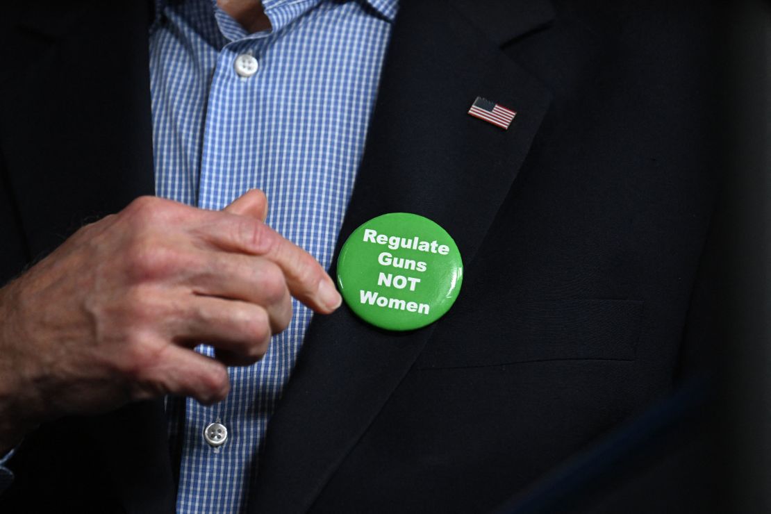 Biden puts on a pin that was thrown to him from the crowd in Atlanta on March 9, 2024.