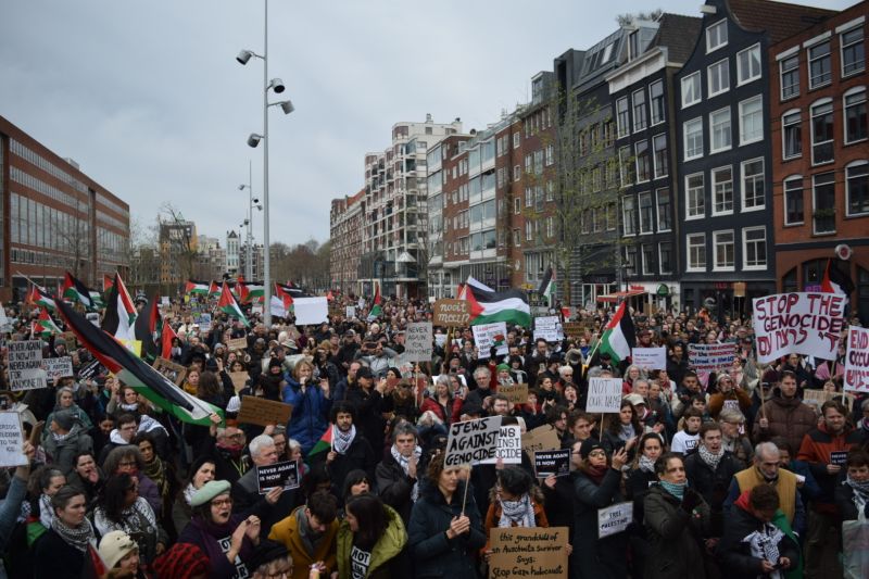 People protested with signs and Palestinian flags near the museum.