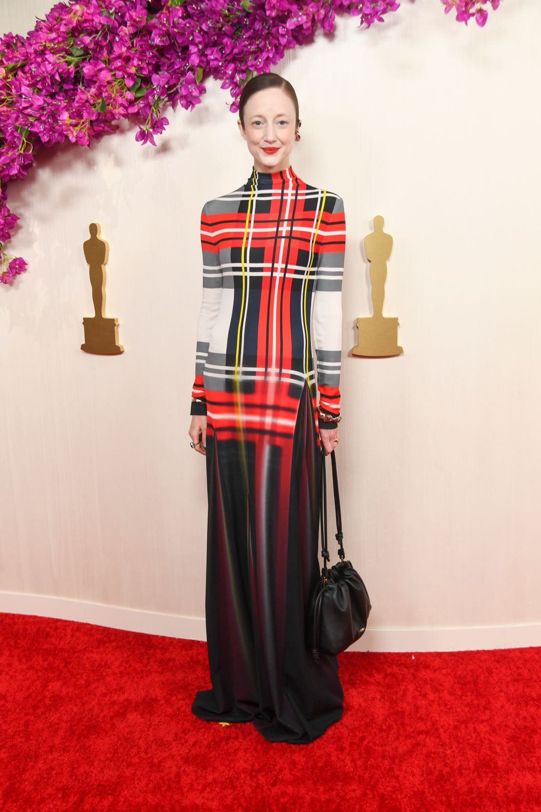 Andrea Riseborough wore an eye-catching long-sleeved Loewe dress with a tartan print.