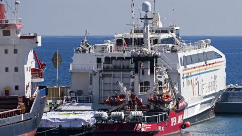 The Open Arms vessel (C) is pictured in the Cypriot port of Larnaca on March 11, 2024. A Cyprus government spokesman said a Spanish charity ship with food aid was set to sail from the island within hours to the coastal Gaza Strip, where the UN has repeatedly warned of famine. The non-governmental group Open Arms said its boat would tow a barge with 200 tonnes of food, which its partner the US charity World Central Kitchen would later unload on Gaza's shores. (Photo by Iakovos Hatzistavrou / AFP) (Photo by IAKOVOS HATZISTAVROU/AFP via Getty Images)