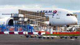 The LATAM Airlines Boeing 787 Dreamliner plane that suddenly lost altitude mid-flight a day earlier, dropping violently and injuring dozens of terrified travellers, is seen on the tarmac of the Auckland International Airport in Auckland on March 12, 2024. (Photo by BRETT PHIBBS / AFP)