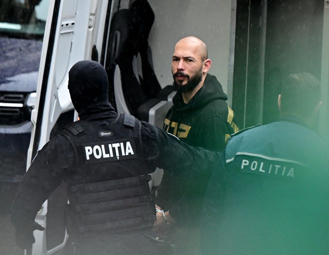 Andrew Tate is led by police officers to the Court of Appeal in Bucharest, Romania on March 12, 2024.