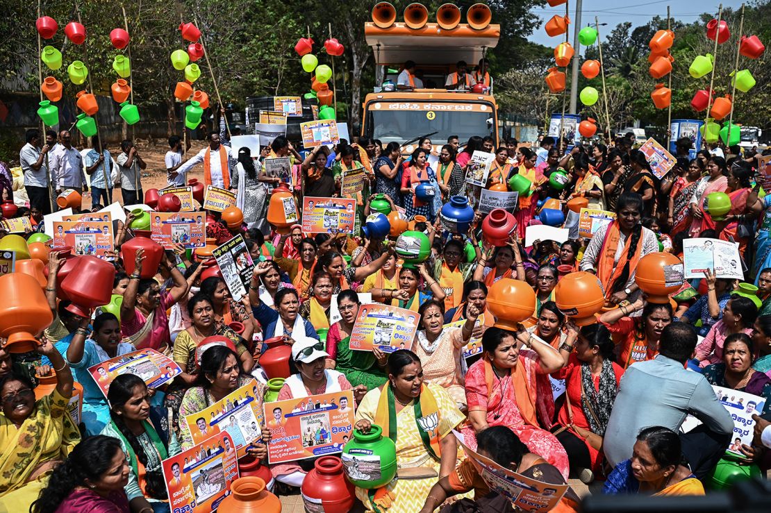 Activists and BJP members hold empty water pots during a protest against the state government over the severe water crisis, in Bengaluru on March 12, 2024.
