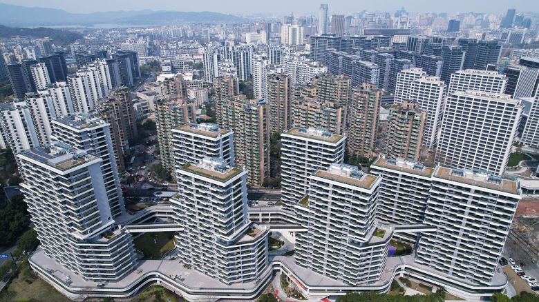 An aerial view is showing buildings in the Shipangqiao Future community in Hangzhou, Zhejiang Province, China, on March 13, 2024. As the only ''high-density old city center'' renovation project in Zhejiang Province, the demolition and resettlement house of the Hangzhou Shifuqiao Future community is now being officially delivered to the residents. The construction of the Hangzhou Shifuqiao Future community has created a ''air square lane'' system featuring three core characteristics: ''three-dimensional market, three-dimensional garden, and three-dimensional connectivity.'' The community includes 1,718 sets of resettlement housing and 1,864 sets of talent rooms, along with neighborhood centers and parks. It is also equipped with top-tier facilities such as schools and medical centers, and it features a layout of 1.45 million square meters of commercial business space, aiming to become a ''high-quality development and construction of common prosperity demonstration zone'' in Hangzhou. (Photo by Costfoto/NurPhoto via Getty Images)
