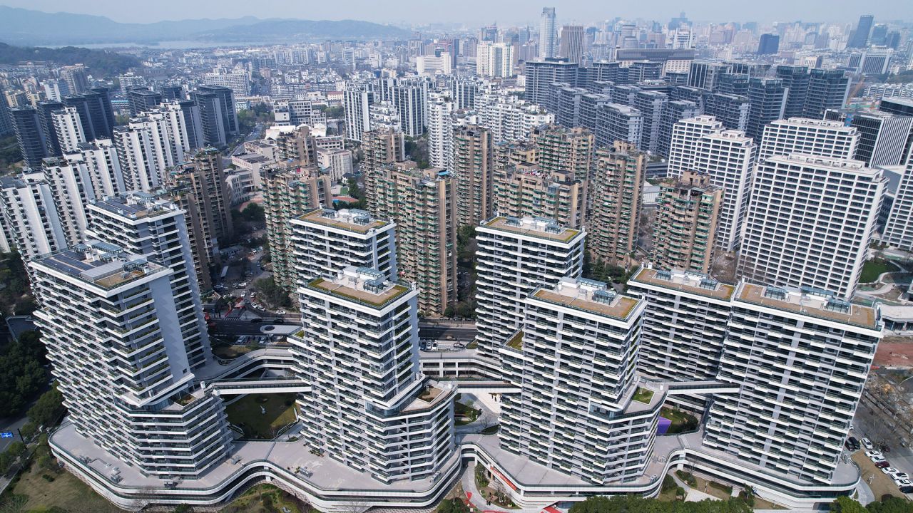 An aerial view is showing buildings in the Shipangqiao Future community in Hangzhou, Zhejiang Province, China, on March 13, 2024. As the only ''high-density old city center'' renovation project in Zhejiang Province, the demolition and resettlement house of the Hangzhou Shifuqiao Future community is now being officially delivered to the residents. The construction of the Hangzhou Shifuqiao Future community has created a ''air square lane'' system featuring three core characteristics: ''three-dimensional market, three-dimensional garden, and three-dimensional connectivity.'' The community includes 1,718 sets of resettlement housing and 1,864 sets of talent rooms, along with neighborhood centers and parks. It is also equipped with top-tier facilities such as schools and medical centers, and it features a layout of 1.45 million square meters of commercial business space, aiming to become a ''high-quality development and construction of common prosperity demonstration zone'' in Hangzhou. (Photo by Costfoto/NurPhoto via Getty Images)