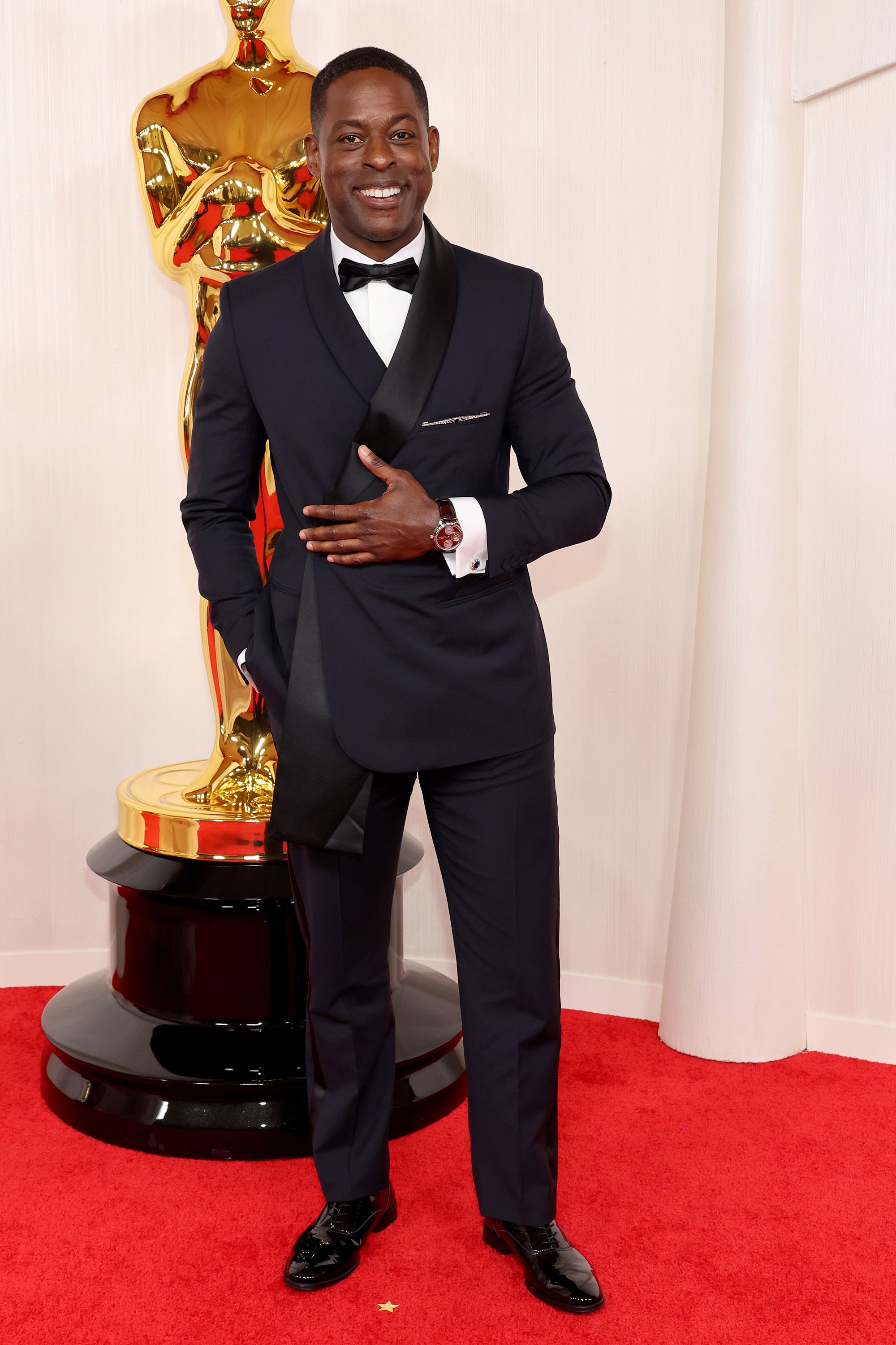 Sterling K. Brown wore a navy Dior Men suit paired with a black satin scarf and bow tie.