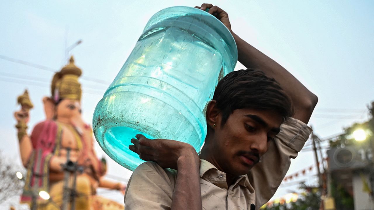 A man carries a water can amid an ongoing water crisis in Bangalore on March 14, 2024.