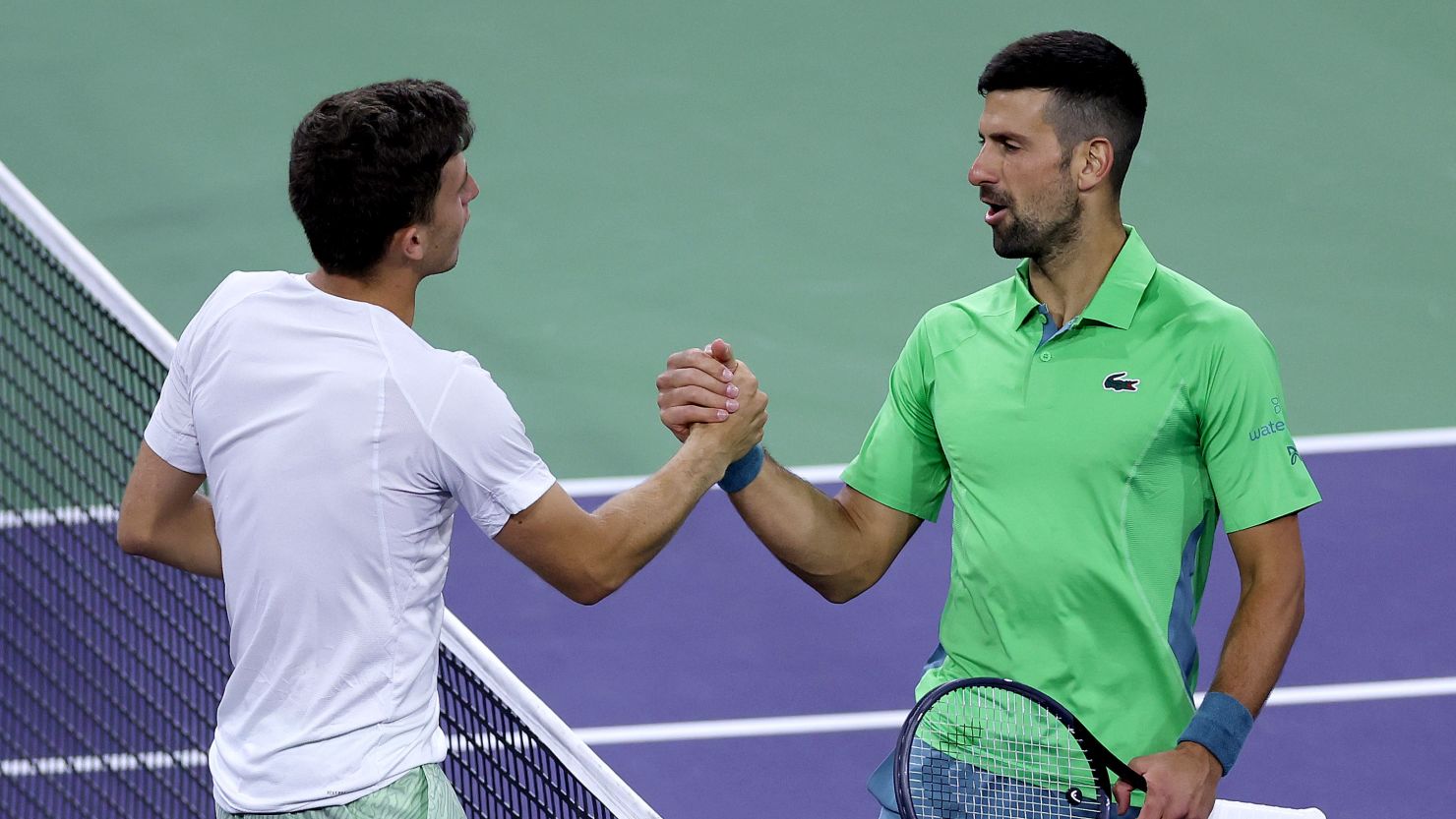 Novak Djokovic and Luca Nardi shake hands after Nardi recorded his famous victory at Indian Wells.