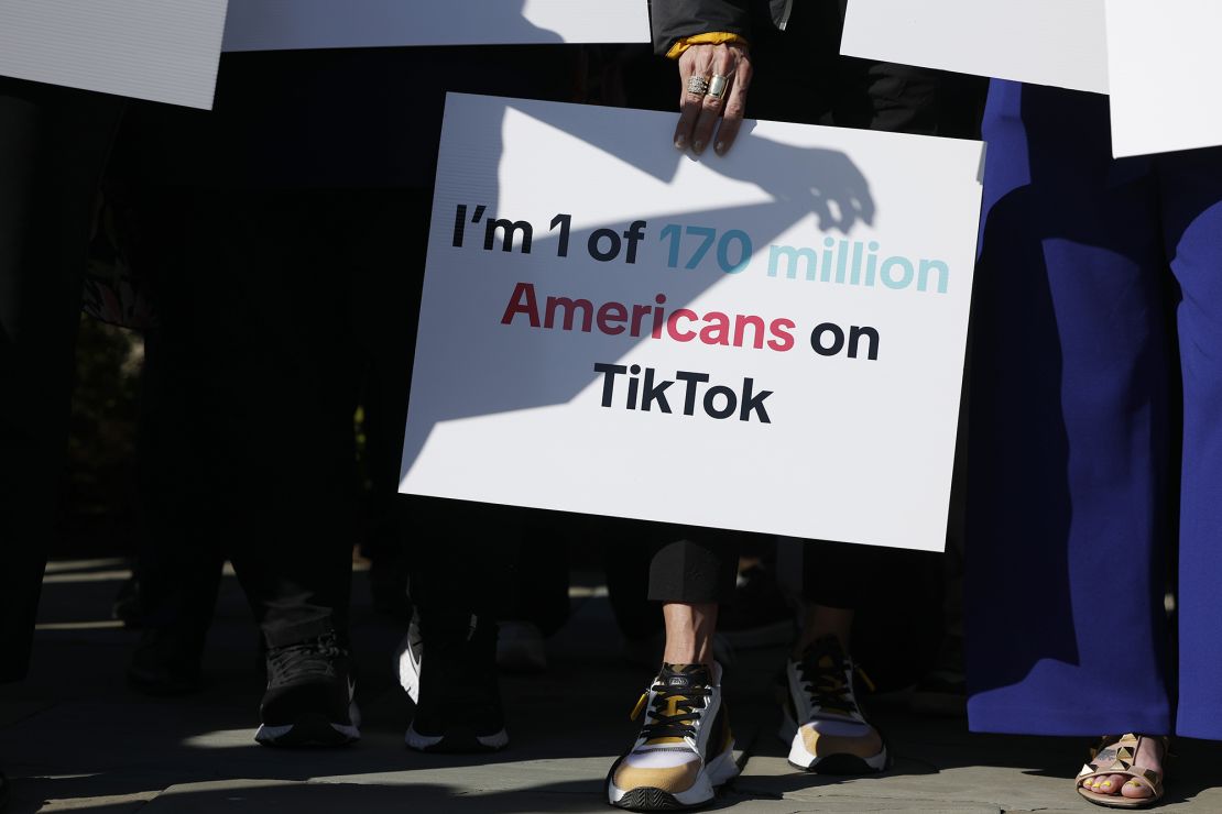 TikTok supporters hold signs at a news conference expressing concerns about the sale-or-ban legislation, outside of the US Capitol Building on March 12, 2024 in Washington, DC