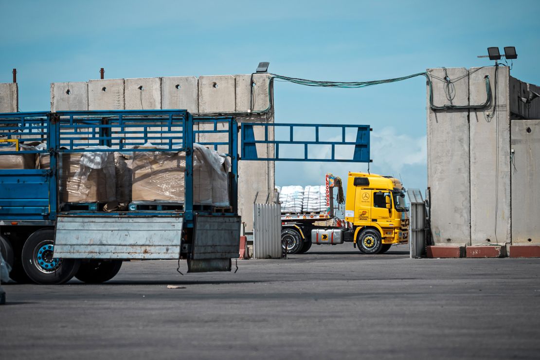 Trucks carrying aid move through security inspections at the Kerem Shalom crossing in March.