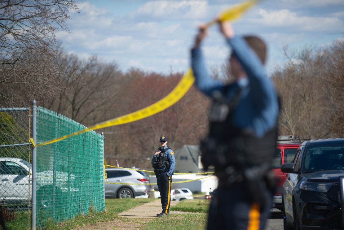 Police officers from the Falls Township Police Department tape off the scene of a shooting on March 16, 2024, in Levittown, Pennsylvania.