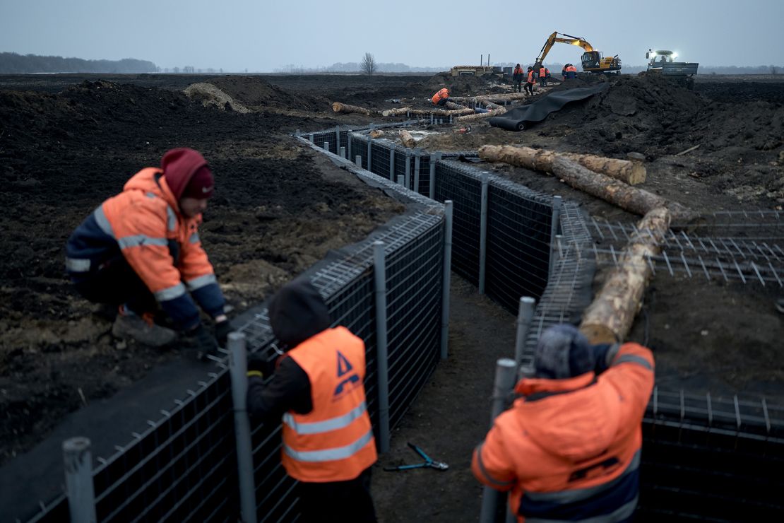 Workers inspect fortifications being built in Ukraine's Sumy region on March 16, 2024. The city of Sumy, near the border, has seen intensified attacks by Russian military groups in recent months.