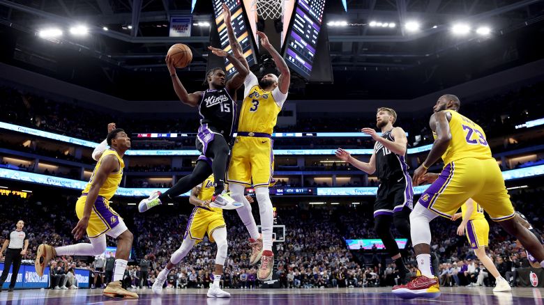 SACRAMENTO, CALIFORNIA - MARCH 13: Davion Mitchell #15 of the Sacramento Kings goes up for a shot on Anthony Davis #3 of the Los Angeles Lakers in the second half at Golden 1 Center on March 13, 2024 in Sacramento, California. NOTE TO USER: User expressly acknowledges and agrees that, by downloading and or using this photograph, User is consenting to the terms and conditions of the Getty Images License Agreement.  (Photo by Ezra Shaw/Getty Images)