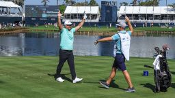 PONTE VEDRA BEACH, FLORIDA - MARCH 14: Ryan Fox of New Zealand celebrates after holing his tee shot on the 17th hole for a hole in one as his caddie Dean Smith reacts during the first round of THE PLAYERS Championship on the Stadium Course at TPC Sawgrass on March 14, 2024 in Ponte Vedra Beach, Florida. (Photo by David Cannon/Getty Images)
