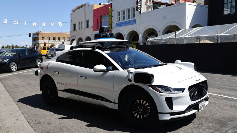 A Waymo autonomous self-driving Jaguar taxi drives near Venice Beach on March 14, 2024 in Los Angeles, California.