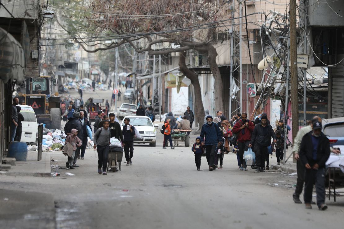 Palestinian residents flee the area near Al-Shifa Hospital, in northern Gaza, on March 18, after Israeli forces stormed the largest medical complex in the strip.