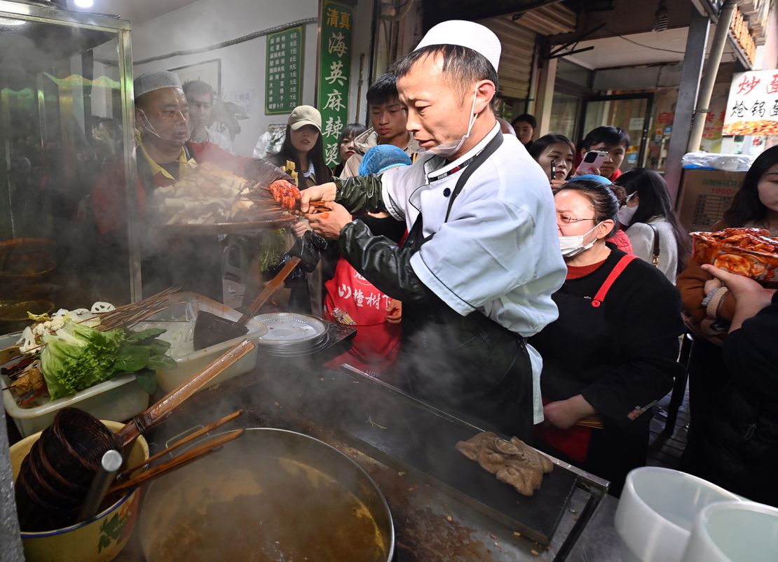 A staff member cooks Tianshui Spicy Hot Pot on March 14, 2024 in Tianshui City, Gansu Province of China.