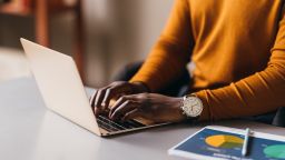Focused African American woman typing on laptop, business concept